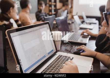 Students in classroom working with laptops Stock Photo