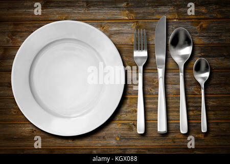 Cutlery set with fork, knife, spoon and plate. Overhead view. Stock Photo