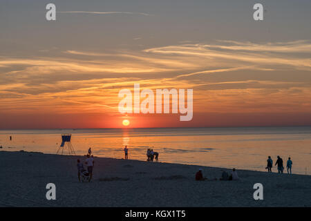 Sarbinowo, Poland -  August 2017 :  People walking on the sea beach in summer at sunset Stock Photo