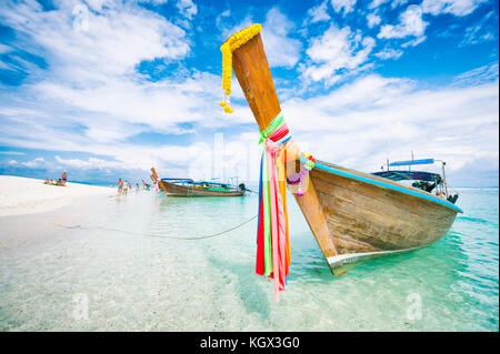 Wooden boat on crystal clear shallow water, Railay Beach ...