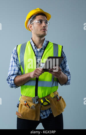 Male architect using digital tablet against white background Stock Photo