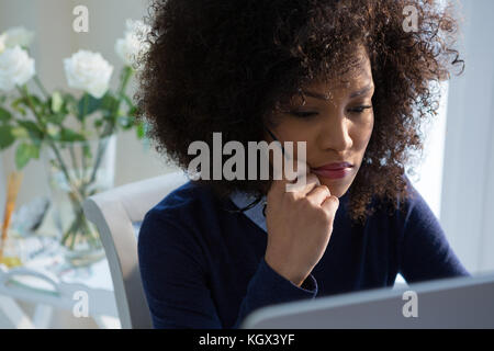 Close-up of beautiful woman working on desktop pc at home Stock Photo