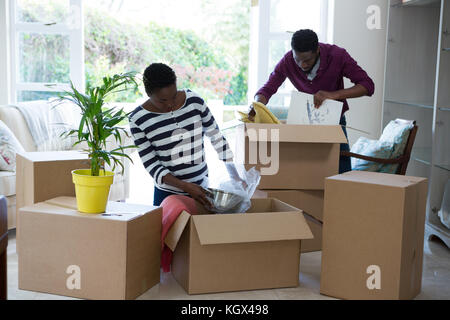 Couple unpacking boxes in new house Stock Photo