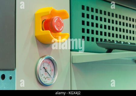Emergency stop button and vacuum gage in machine Stock Photo