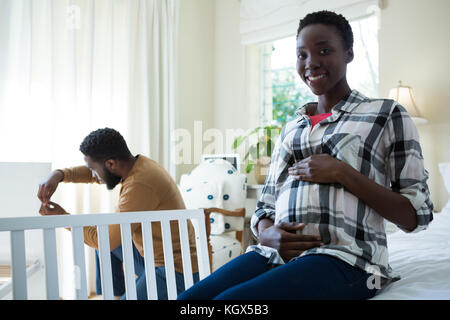 Woman feeling the presence of baby in stomach at home Stock Photo