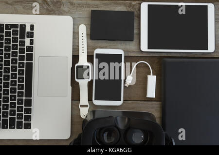 Overhead of various electronic gadgets on wooden surface Stock Photo