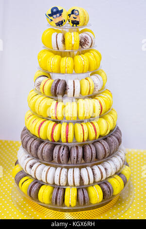 Yellow, white and brown cake macrons on stand for kids birthday party Stock Photo