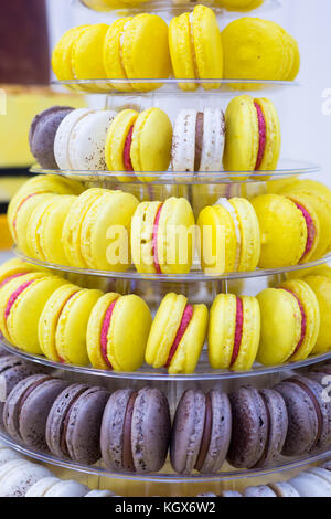 Yellow, white and brown cake macrons on stand for kids birthday party Stock Photo
