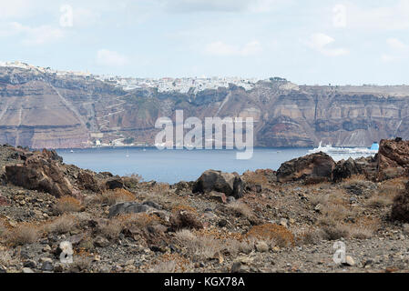 Exotic rocky road to the crater of the volcano. The volcano is located in the famous Caldera of Santorini. On a Sunny day. Stock Photo