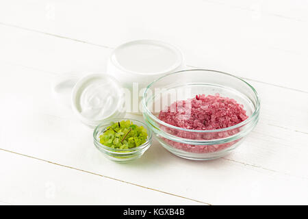 Spa concept with salt, mint, lotion, towel on white background Stock Photo