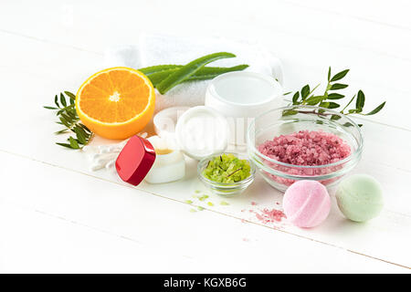 Spa concept with salt, mint, lotion, towel on white background Stock Photo