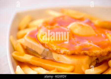 Francesinha - a Portuguese sandwich served with french fries, originally from Porto, Portugal Stock Photo