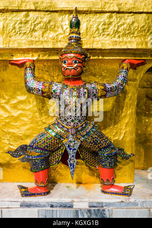Red demon guardian supporting Wat Phra Kaew (buddhist temple), Grand Palace, Bangkok, Thailand Stock Photo