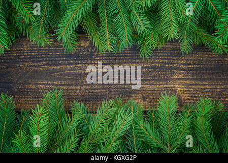 Christmas decoration concept - spruce branches on an old wooden vintage planks with copy space ( high details). Stock Photo