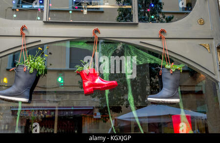 Hanging plant pots made from Wellington boots outside a shop in Barcelona, Spain. Stock Photo