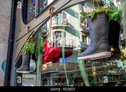 Hanging plant pots made from Wellington boots outside a shop in Barcelona, Spain. Stock Photo
