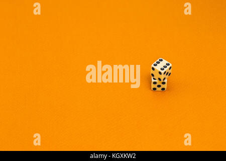 Isolated white dice on a orange background Stock Photo