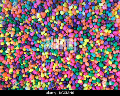 Close up on many colorful candy pieces. Bright colorful florescent colors. Flat lay top view background Stock Photo