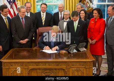 U.S. President Donald Trump signs H.J. Res.111 - the Disapproving of the Consumer Financial Protection Bureaus Arbitration Agreement Rule into a law in the White House Oval Office November 1, 2017 in Washington, DC.  (photo by Joyce N. Boghosian via Planetpix)