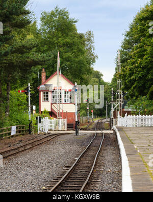 A railway crossing and traditional railway signal box at Alston on the South Tynedale railway in Northern England. Stock Photo