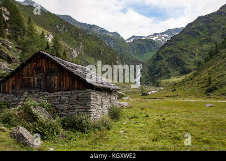 Old barn with stone walls in dolomite valley Stock Photo