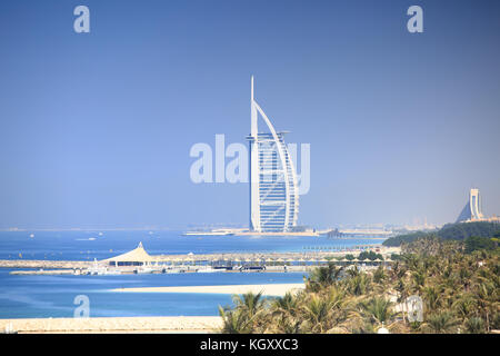 Luxury seven stars hotel in Dubai. Burj Al Arab Jumeirah resort hotel on blue sky background. Sunny Dubai resort. Stock Photo