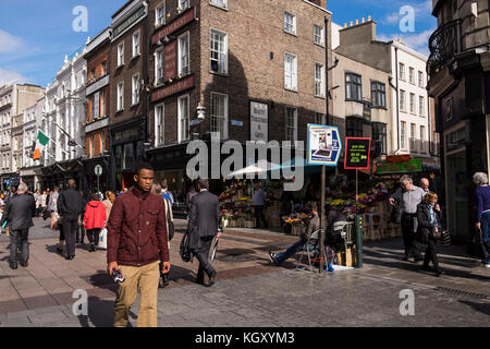 Street scenes on the corner of Grafton street and Duke Street, Dublin, pedestrians, shoppers, sandwich board advertising boards, on a sunny day, Irela Stock Photo