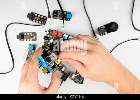 Connecting electrical parts above view. Assembling  robot kit Stock Photo