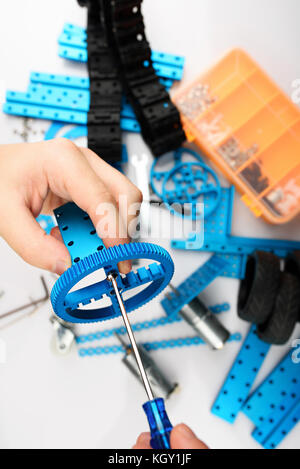 Assemble of DIY kit close up view. Hands making RC model Stock Photo
