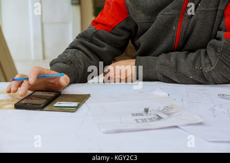 Hands of Engineer working on blueprint,Construction concept. Engineering tools. Stock Photo