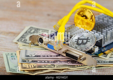 Gold coin of bitcoin against the background of the coin bitcoin dollars graphic card internet wire Stock Photo