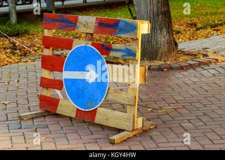 Sign of detour travel. Pit on the road. repair work sign circumvent bypass Stock Photo