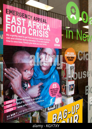 Oxfam emergency appeal poster in charity shop window, East Africa food crisis Stock Photo