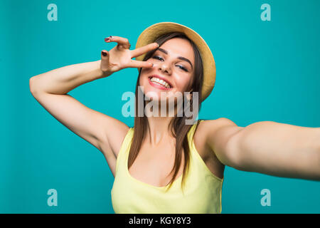 Young pretty taking a selfie on a color background Stock Photo