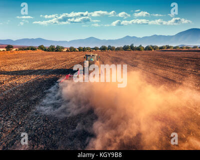 Tractor cultivating field at autumn ,aerial view Stock Photo