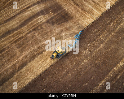 Tractor cultivating field at autumn, aerial view Stock Photo