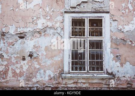 Old window with white lattice in vintage wall. Film effect. Space on left side Stock Photo