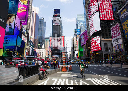 Unidentified people on the Times Square, New York. Times Square is the most popular tourist location in New York City Stock Photo