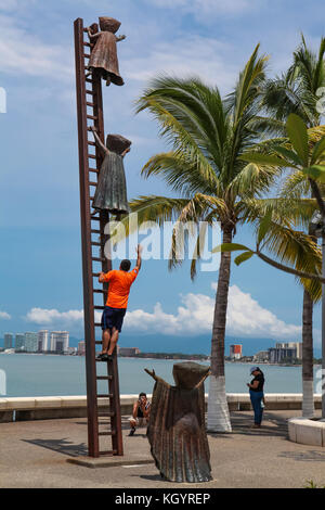 PUERTO VALLARTA, MEXICO - SEPTEMBER 6, 2015: Unidentified people by Searching for Reason statue at Puerto Vallarta, Mexico. Sculpure was made by Sergi Stock Photo