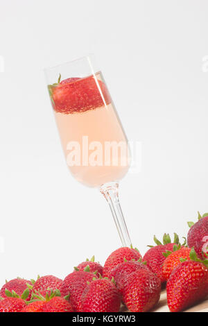 fresh strawberry on a glass filled with wine Stock Photo