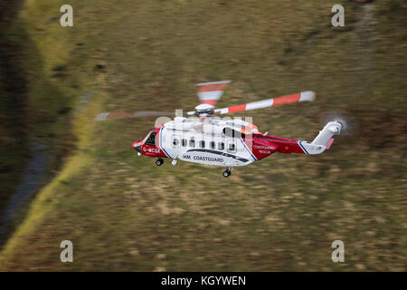 HM Coastguard Search & Rescue Helicopter Rescue 936, conducting low flying training in Snowdonia. Stock Photo