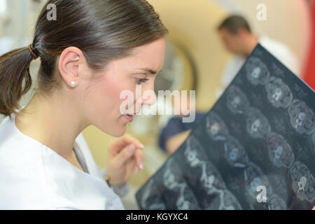 young female doctor talking checking brain scans Stock Photo