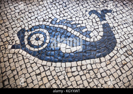 Traditional portuguese pavement calcada portuguesa with a fish detail in Macau Stock Photo