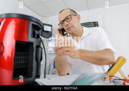 man repairing a coffee maker Stock Photo