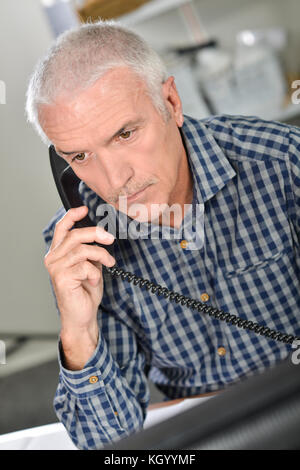 Architect on the phone to a client Stock Photo