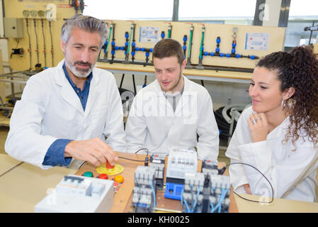 student and teacher working on a project together Stock Photo
