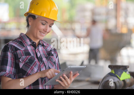 female construction engineer working on laptop at site Stock Photo