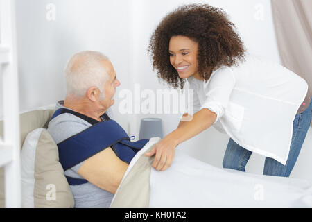 caring for a sick senior man in at home Stock Photo