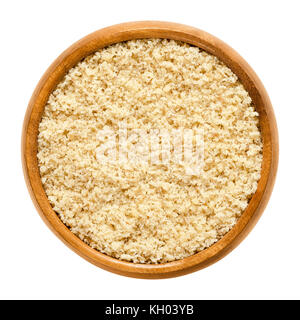 Ground walnuts in wooden bowl. Walnut meal, used in bakery. Grounded kernels, the seeds of the common walnut tree, Juglans regia. Stock Photo