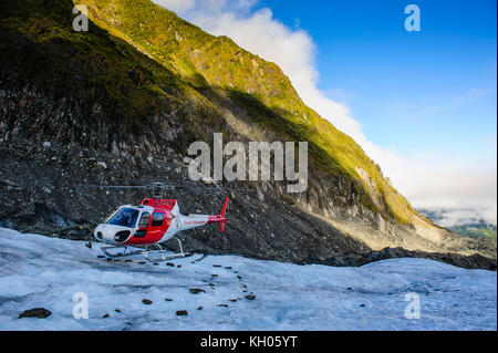 Helicopter transporting tourists into Fox Glacier, South Island, New Zealand Stock Photo